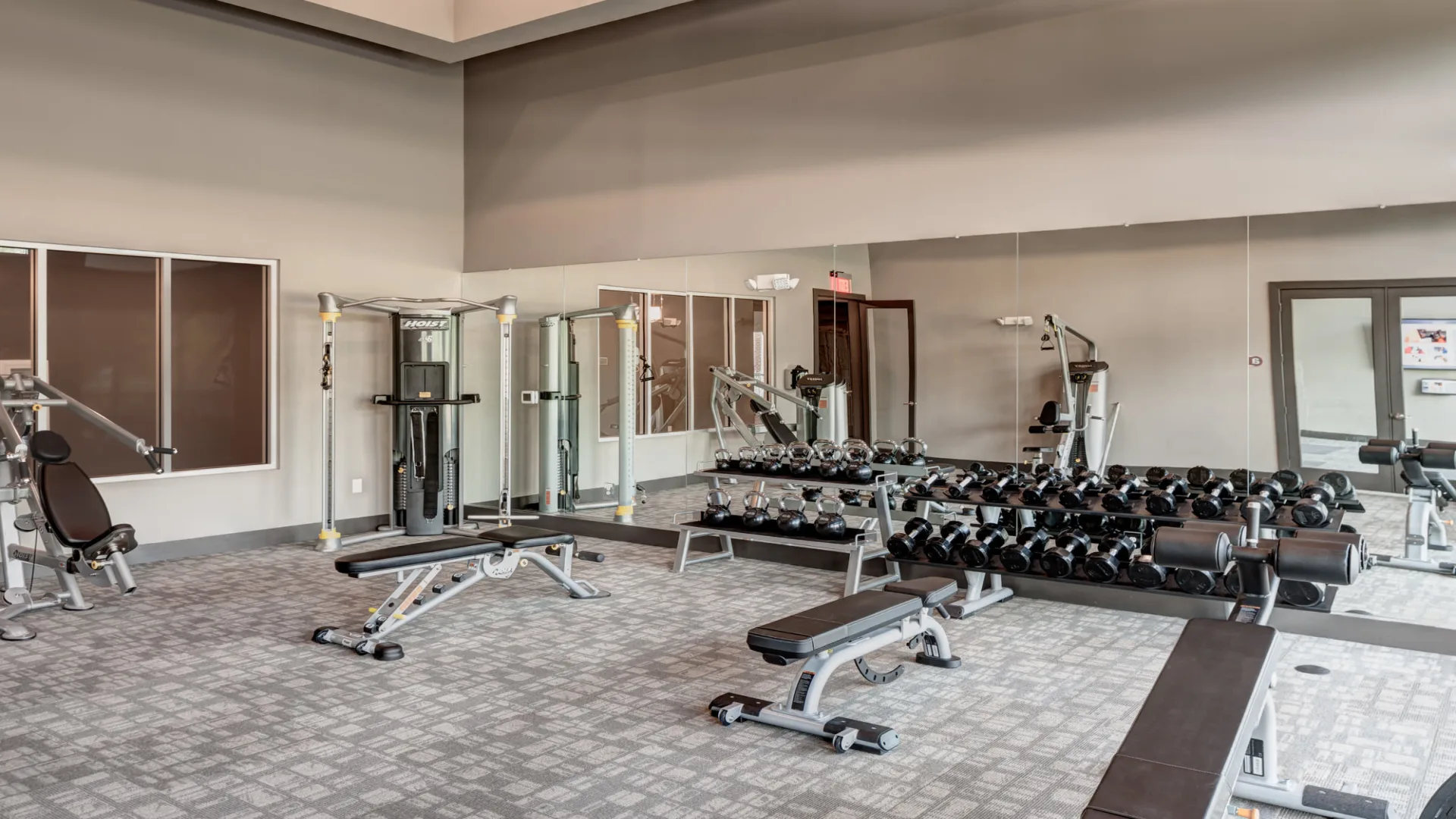 a gym room with weights and exercise equipment at The Anatole at  Pines