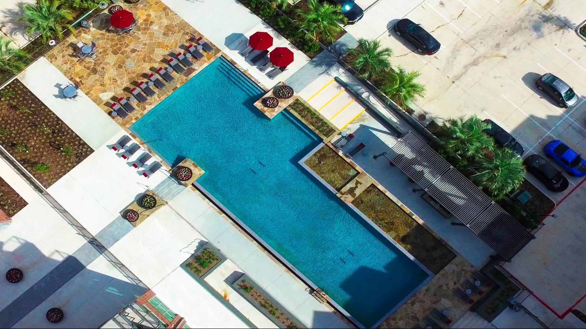 an aerial view of a pool and a parking lot at The Anatole at  Pines