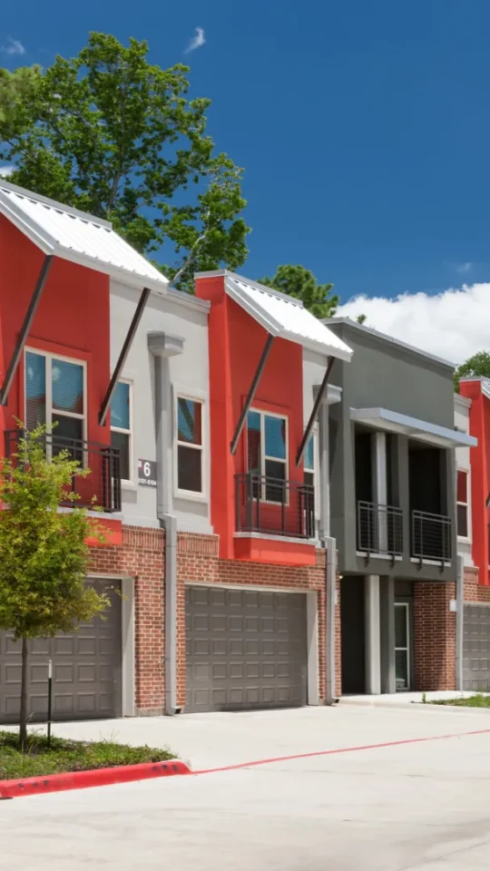 the exterior of a row of townhomes in a residential neighborhood at The Anatole at  Pines