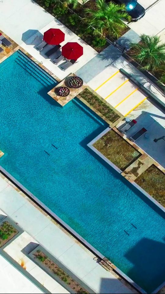 an aerial view of a pool and a parking lot at The Anatole at  Pines